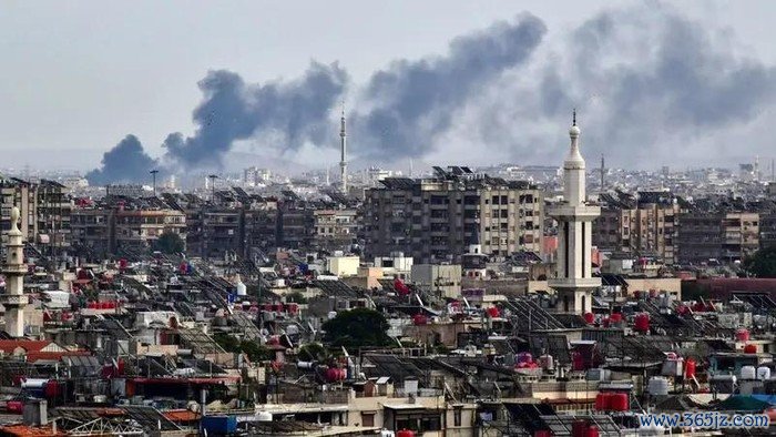 Smoke billows above buildings after an Israeli strike on the outskirts of Damascus, Syria, on November 22, 2023. (AFP)